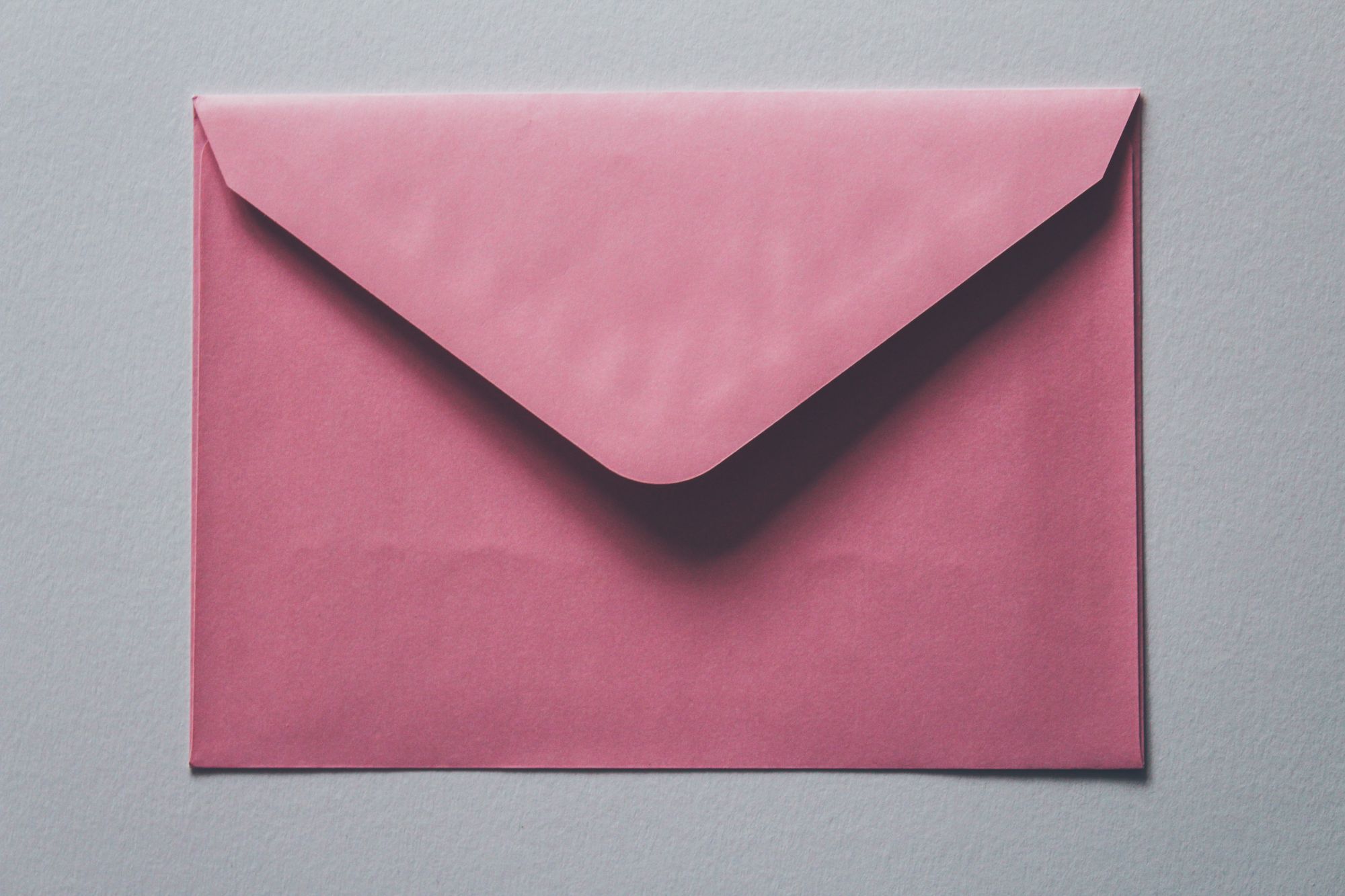 Stock photo of a pink envelope.